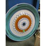 LARGE POOLE TYPE CHARGER WITH A CIRCULAR AND LOOPED DESIGN TO THE CENTRE WITHIN A GREEN WASH BORDER,