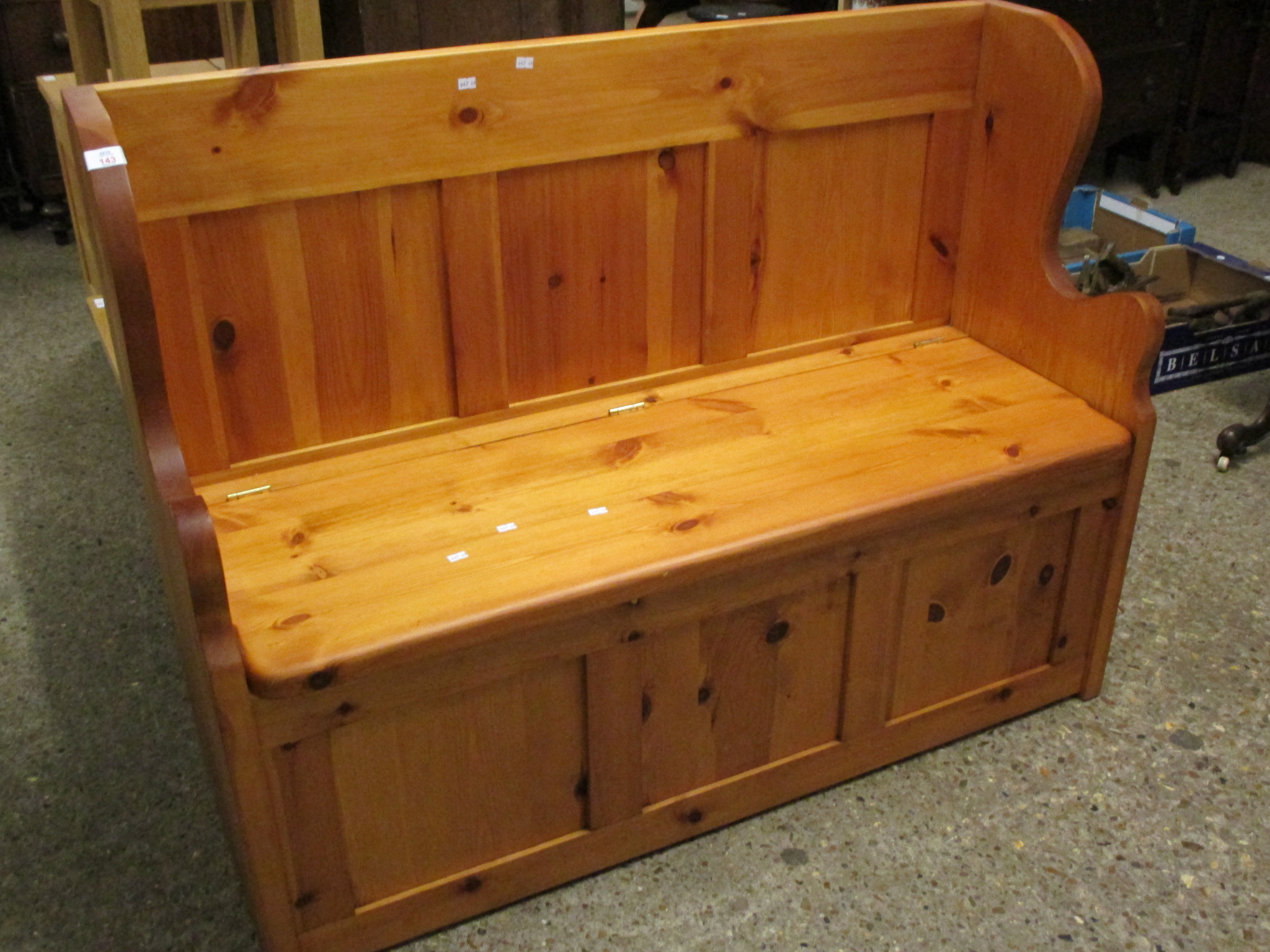 STAINED PINE FRAMED LIFT UP TOP BENCH SETTLE WITH THREE PANELLED FRONT AND SHAPED SIDES