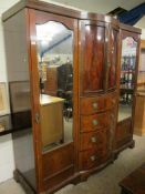 19TH CENTURY COMPENDIUM WARDROBE CENTRALLY FITTED WITH TWO BOW FRONTED CUPBOARD DOORS OVER FOUR