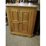 PINE CORNER CUPBOARD WITH TWO PANELLED CUPBOARD DOORS WITH TURNED KNOB HANDLES