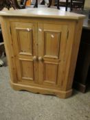 PINE CORNER CUPBOARD WITH TWO PANELLED CUPBOARD DOORS WITH TURNED KNOB HANDLES