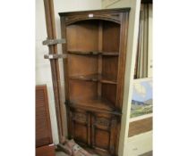 20TH CENTURY OAK FRAMED CORNER CUPBOARD WITH TWO FIXED SHELVES OVER TWO PANELLED DOORS