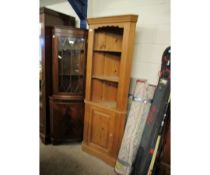 PINE FRAMED FLOOR STANDING CORNER CUPBOARD WITH TWO FIXED SHELVES OVER PANELLED CUPBOARD DOOR