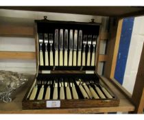 EARLY 20TH CENTURY OAK CASED CANTEEN OF 12 EACH DESSERT KNIVES AND FORKS, EACH WITH POLISHED