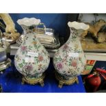 PAIR OF ORIENTAL INFLUENCED FLORAL PRINTED VASES ON GILDED STANDS