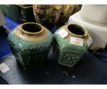 TWO ORIENTAL POTTERY VASES OF FACETED FORM WITH GREEN GLAZED PANELS WITH FLORAL DISPLAYS AND CHINESE