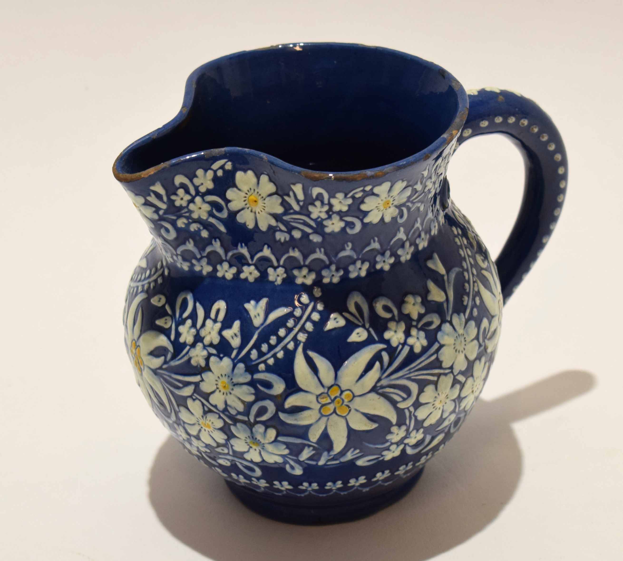 Thune Pottery jug, the blue ground decorated in white with floral sprays, 12cm high - Image 2 of 4