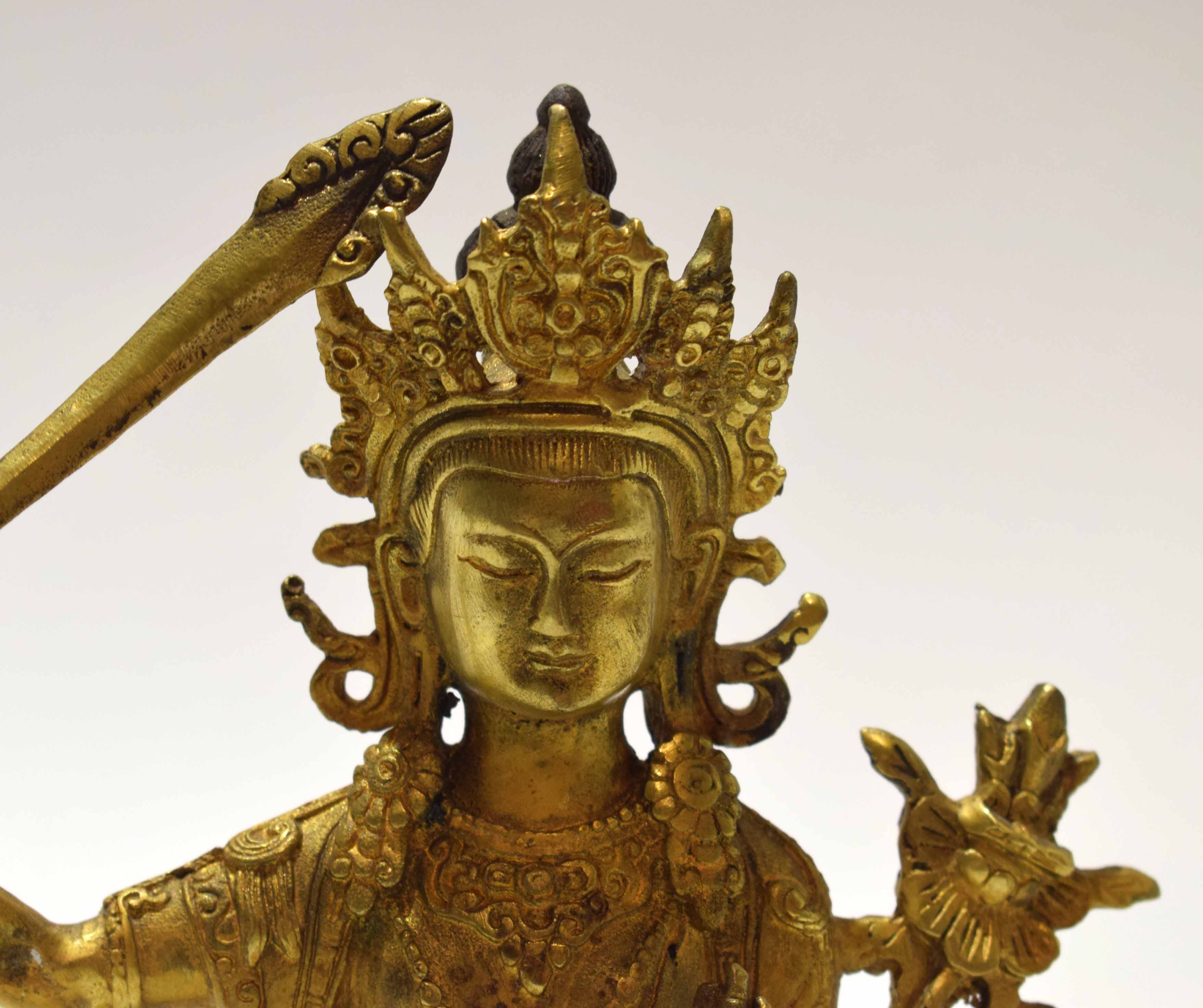 Gilt metal model of a Buddhistic deity in classic pose with inscription to rear, 21cm high - Image 7 of 8