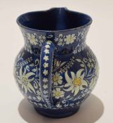 Thune Pottery jug, the blue ground decorated in white with floral sprays, 12cm high