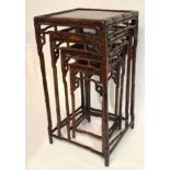 Nest of four Oriental hardwood tables, all of square form with moulded frames and spindle type