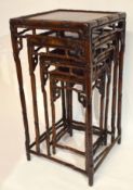 Nest of four Oriental hardwood tables, all of square form with moulded frames and spindle type