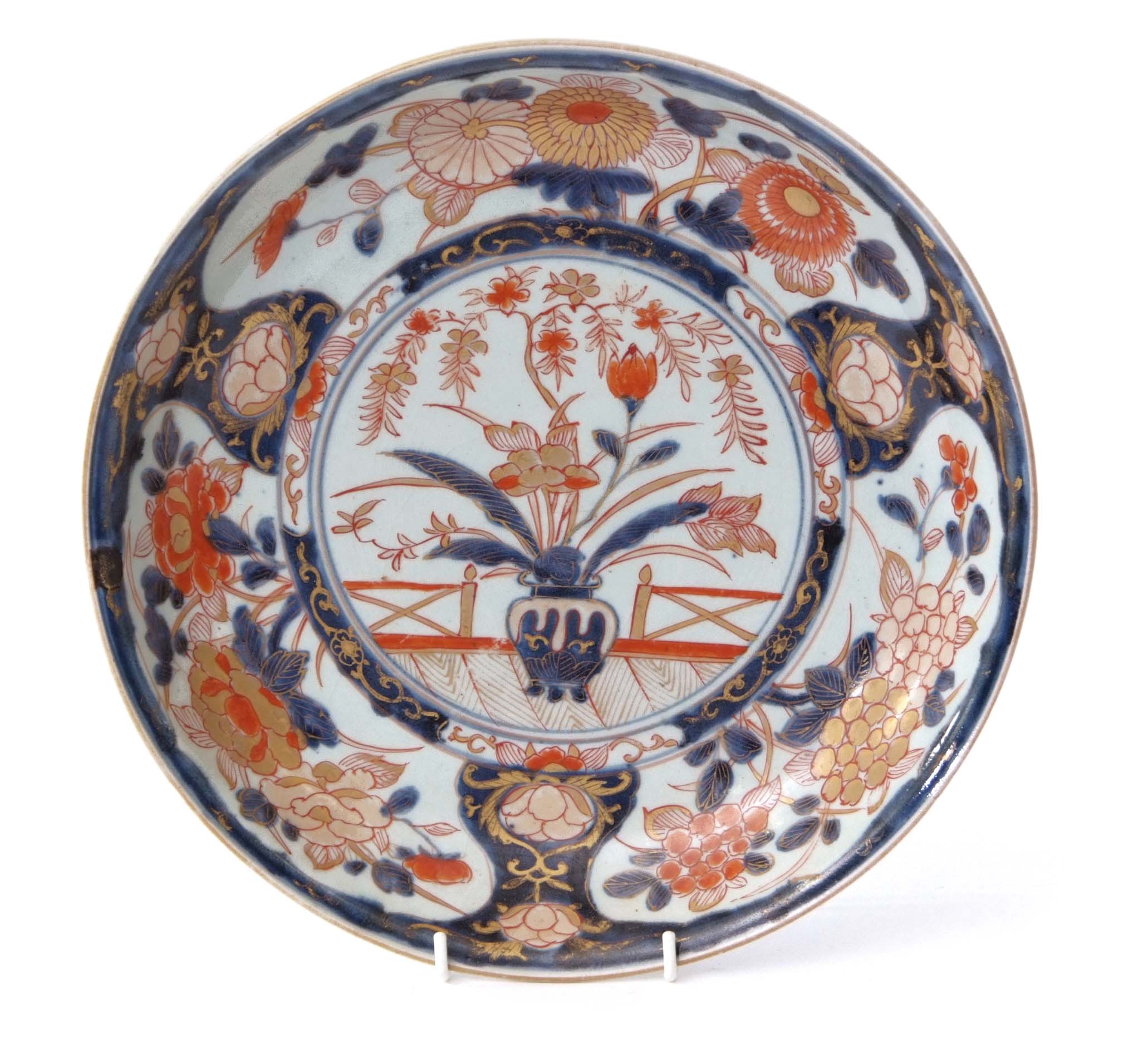 Large 19th century Japanese Imari charger, the centre decorated with a vase of flowers in iron red