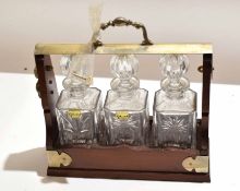 An oak and silver plated mounted three bottle tantalus circa early 20th century, 35cm wide