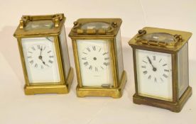 Group of three late 19th/early 20th century brass carriage clocks, white enamel dials and Roman