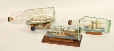 Group of three bottles enclosing models of ships, (3)