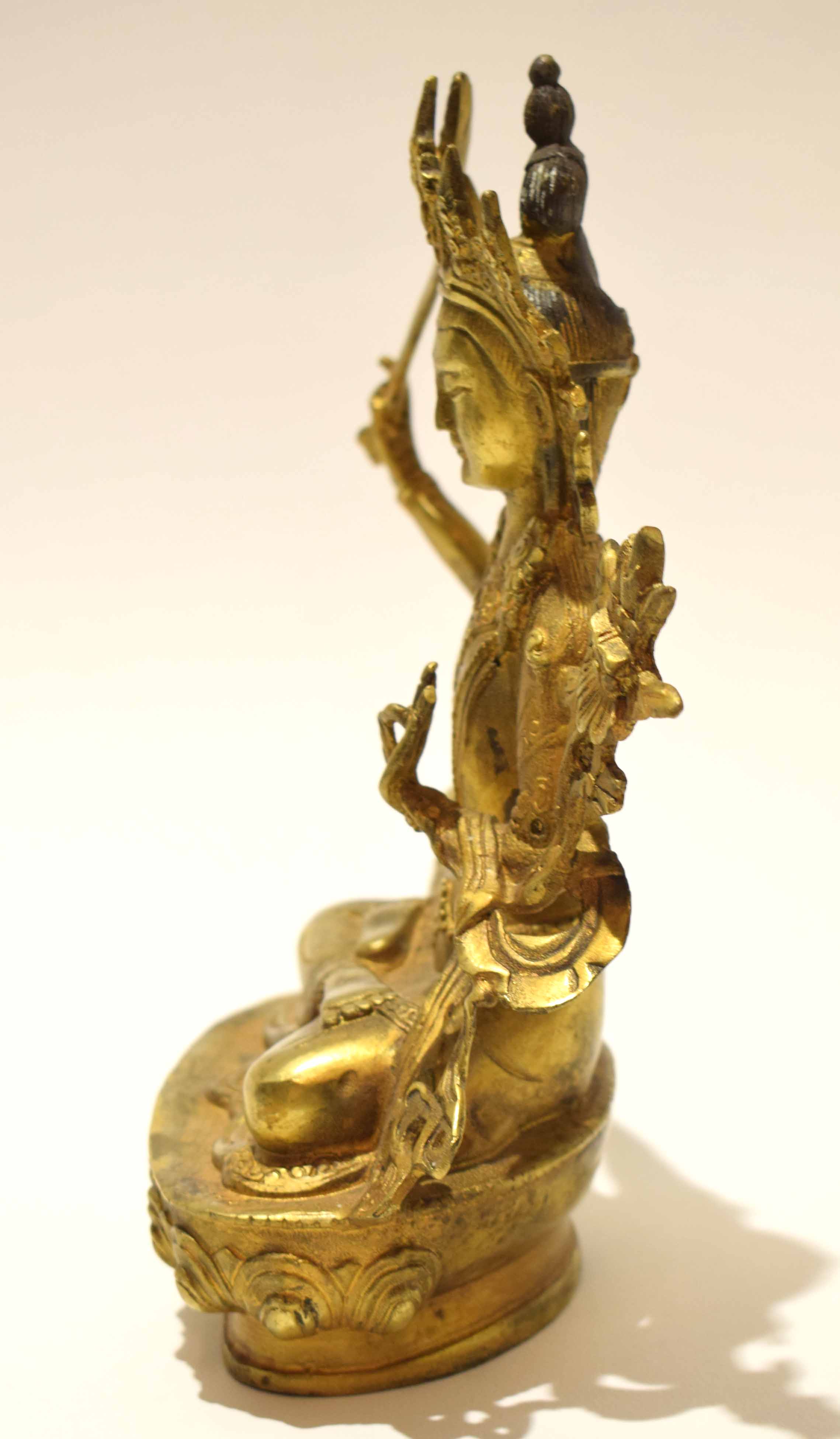 Gilt metal model of a Buddhistic deity in classic pose with inscription to rear, 21cm high - Image 2 of 8