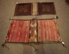 Two Caucasian saddle bag carpets, one decorated in the Bokhara manner with geometric lozenges and