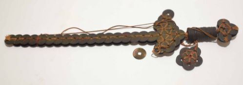 Unusual Oriental dagger made out of coinage stitched together with rope, 44cm long