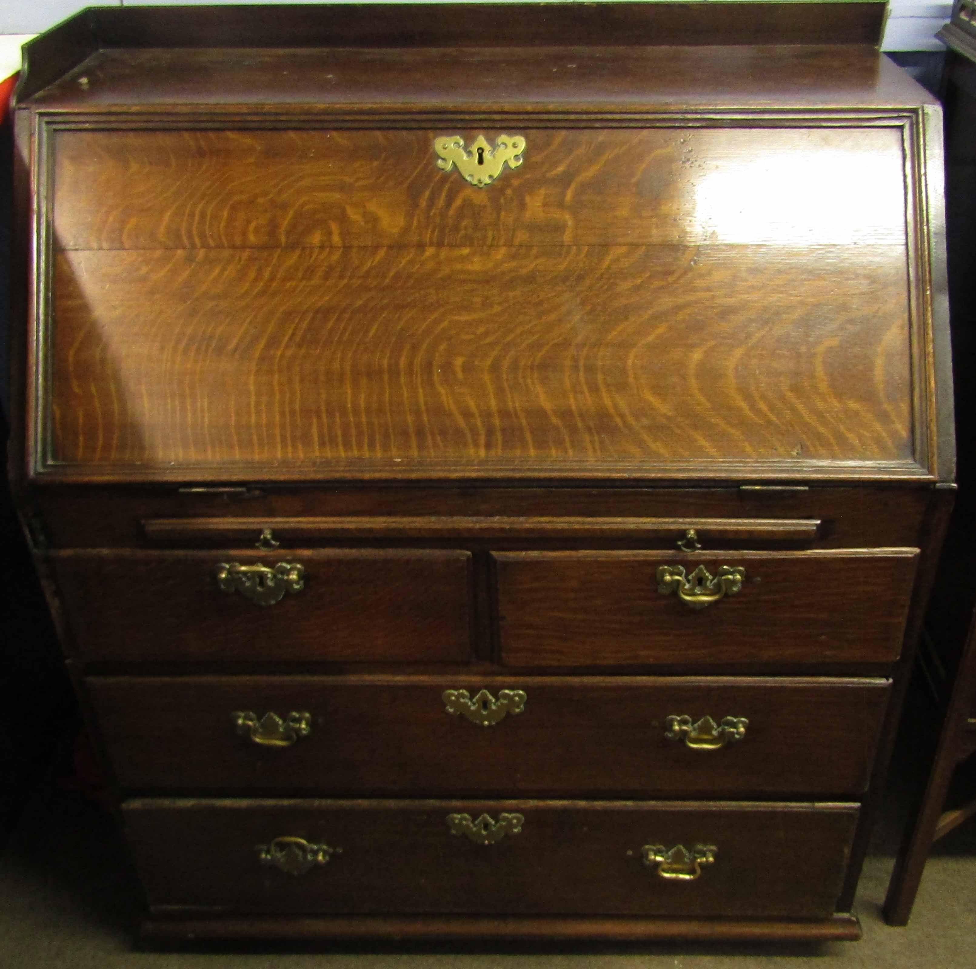 18th century oak bureau, applied with a later galleried top over fall front enclosing fitted