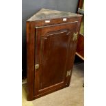 18th century oak wall hanging corner cupboard, single moulded panel door opening to reveal three