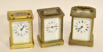 Group of three brass carriage clocks, early 20th century, all with white enamel dials and Roman