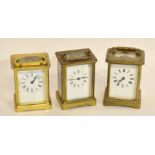 Group of three brass carriage clocks, early 20th century, all with white enamel dials and Roman