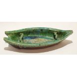Pottery model of a boat, probably Oriental, with a green glaze (a/f), 44cm long