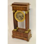 Mantel clock in neo-classical style, the dial supported by four classical columns, the frame with