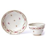 Lowestoft porcelain ogee shaped tea bowl and saucer circa 1790, with gilt and puce design, the