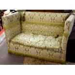 Early 20th century Knole sofa, of typical drop ends and rope ties to corners, upholstered in green