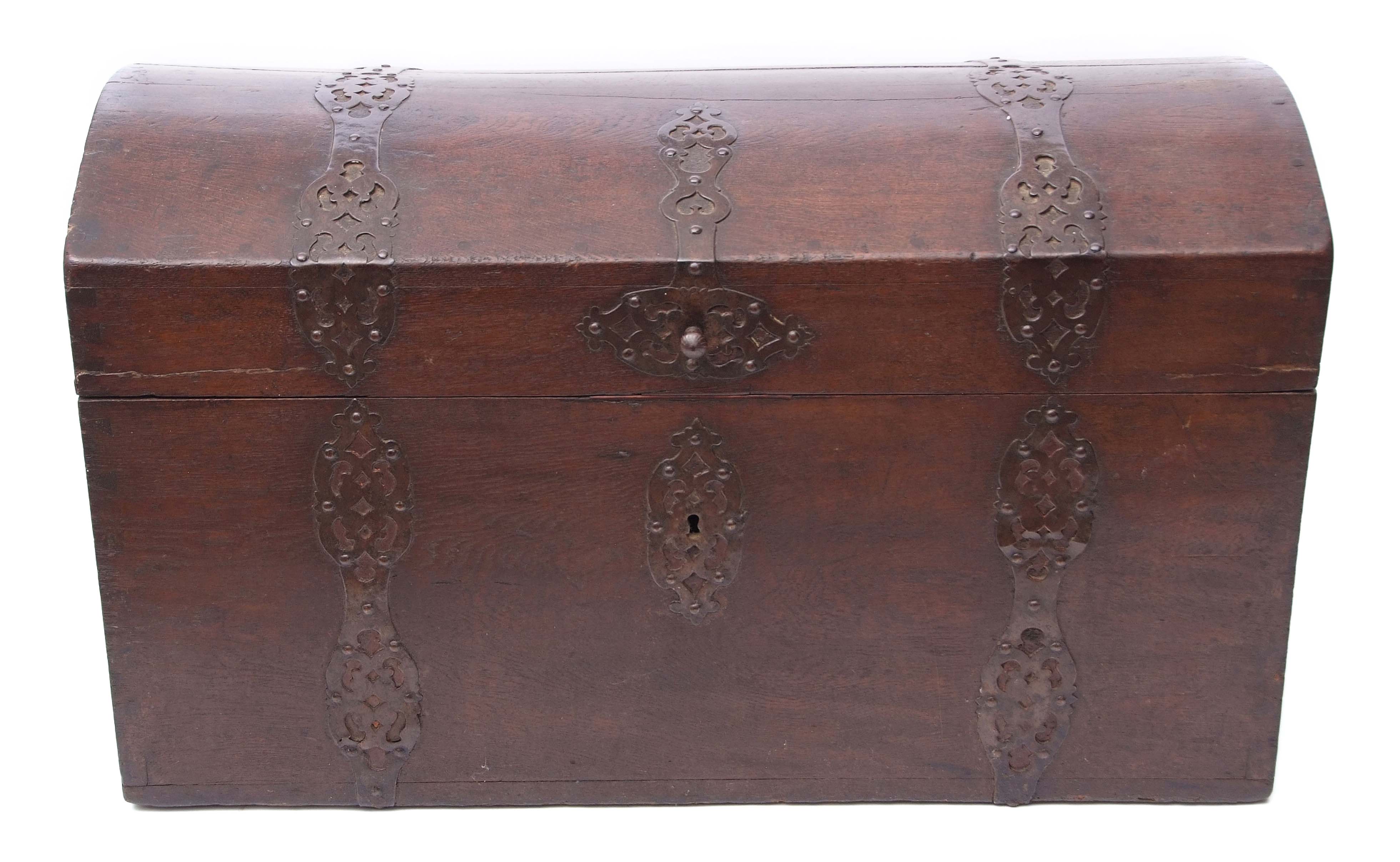 Heavy oak trunk or coffer with domed top and pierced metal strapwork mounts, applied at either end