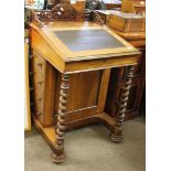 19th century rosewood Davenport with scroll carved fretwork pediment, lifting lid below enclosing
