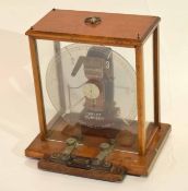 Measuring machine for electric current by The Electrical Company Manchester, in light oak frame,