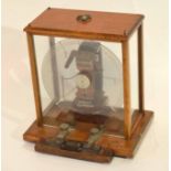 Measuring machine for electric current by The Electrical Company Manchester, in light oak frame,