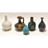 Group of high fired pottery wares comprising a Pilkington green glaze vase, two further glazed vases