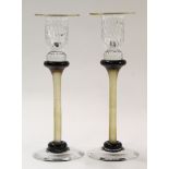 Pair of Art glass candlesticks with gilt rim and coloured stems with a black collar at base, the