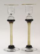 Pair of Art glass candlesticks with gilt rim and coloured stems with a black collar at base, the