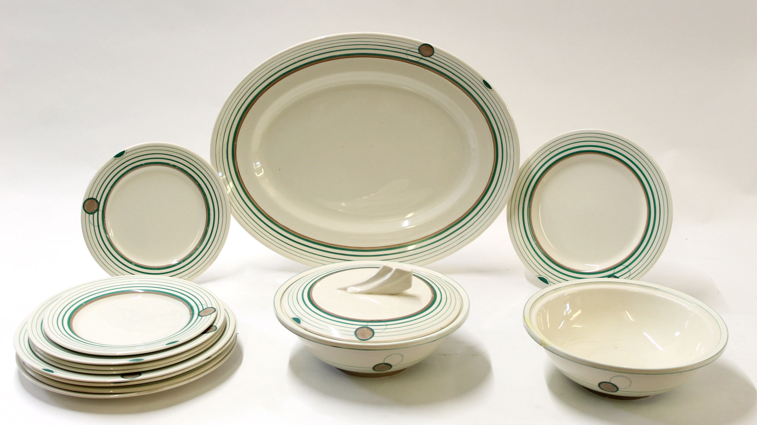Group of Clarice Cliff dinner wares decorated with a green ringed geometric design comprising two
