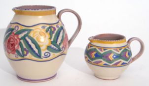 Two 1930s Poole Pottery globular jugs, the larger with a design of roses and flowers, the smaller