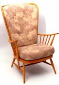 Ercol blond wood wing back armchair with floral upholstered cushions