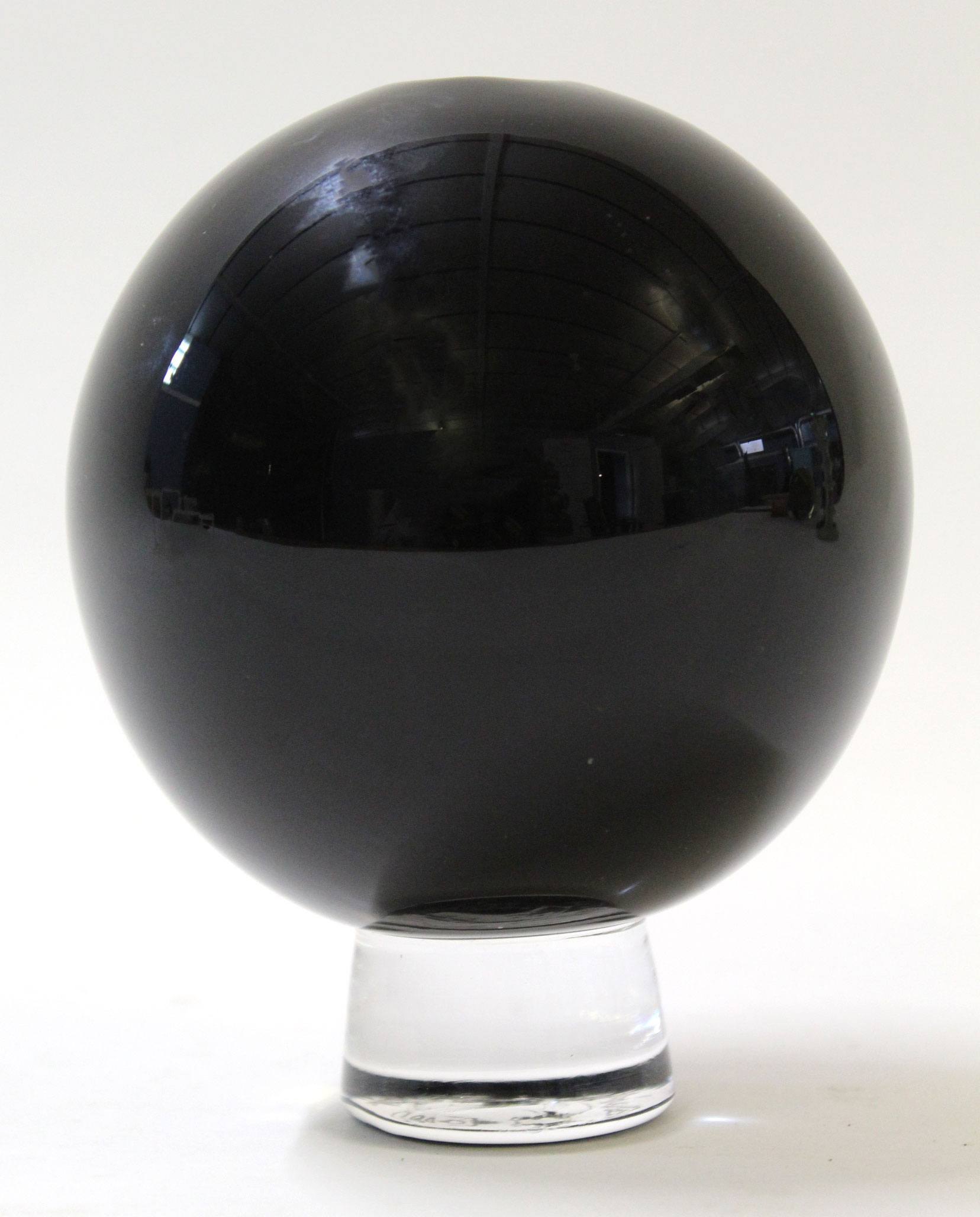 Art Glass vase shaped as a ball on a short stemmed foot, the base engraved Gillies Jones, 14cm high