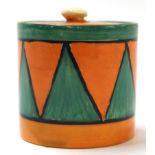 Clarice Cliff Bizarre jam pot and cover decorated with a geometric design in green and orange,