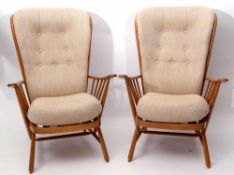 Pair of modern Ercol blonde wood wingback armchairs with beige upholstered cushions (2)