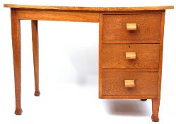 Mid century light oak three-drawer desk, bears inscription "For 5gns! St Thomas Street, Bristol,