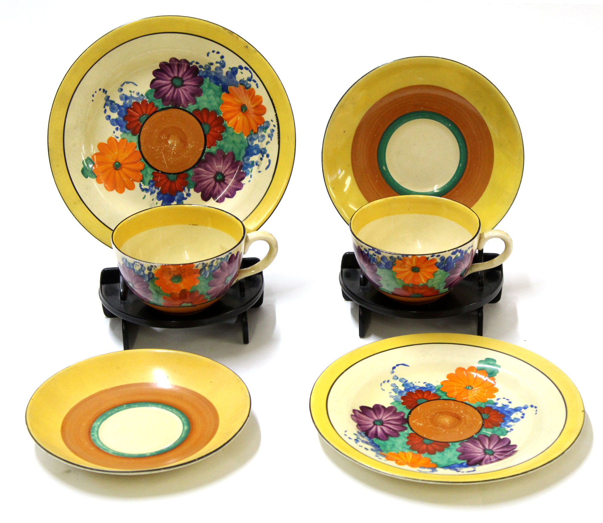 Two Clarice Cliff Gay Day trios, decorated with floral pattern with Bizarre back stamp to base (6)