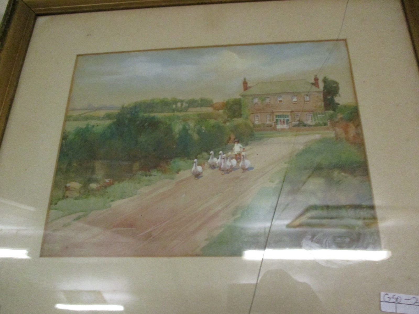 FRAMED WATERCOLOUR OF A FARMHOUSE AND A MAN DRIVING GEESE, APPROX 45CM X 53CM