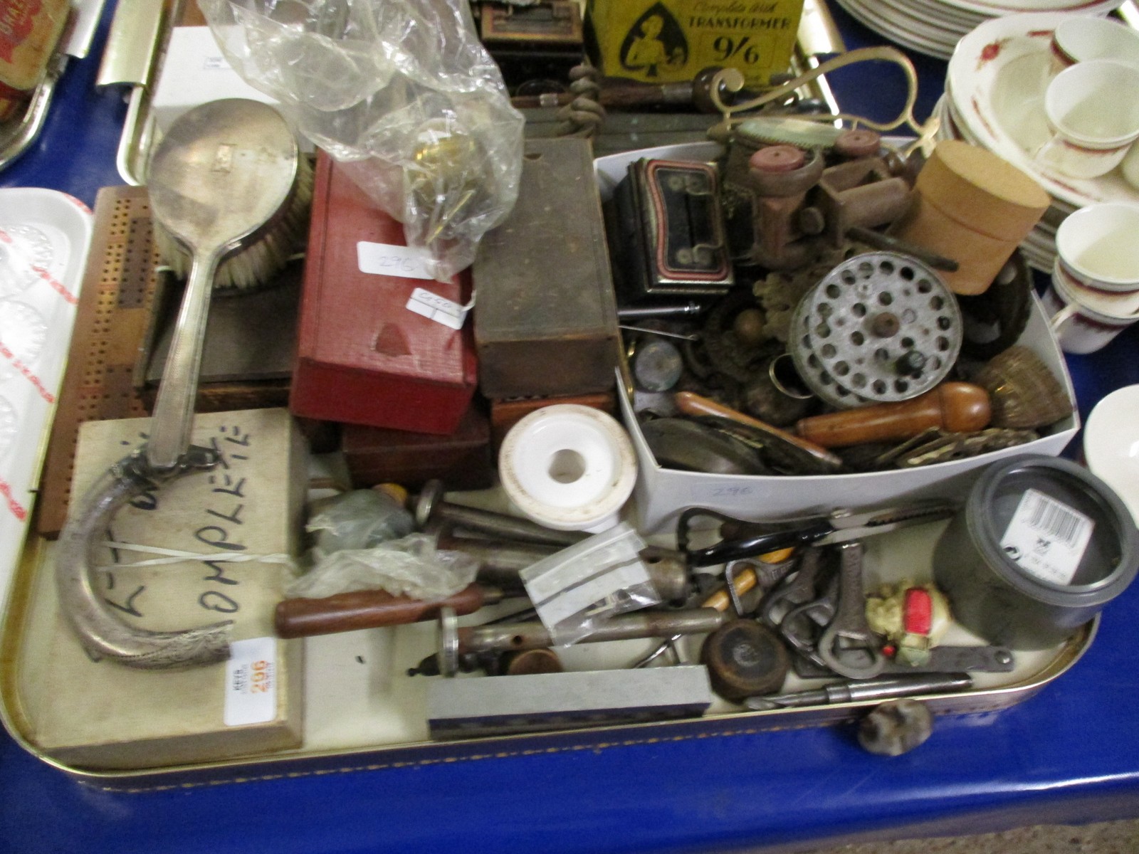 TRAY OF VARIOUS CASED DOMINO SETS, HORSE BRASSES, WOODEN MODEL OF A TRACTOR ETC