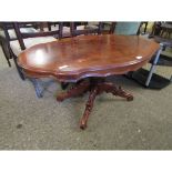 WALNUT AND MAHOGANY SHAPED COFFEE TABLE ON A CARVED QUATREFOIL BASE