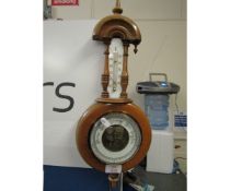 TEAK SMALL WHEEL BAROMETER WITH ARCHED TOP AND TURNED FINIAL