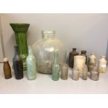 Quantity of earthenware bottles, a green plant stand & a large bulbous glass vase